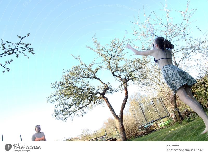 Badminton in the garden Shuttlecock Playing Leisure and hobbies Ball sports Fitness Colour photo Exterior shot Sports Joy Summer Day White Light Sports Training