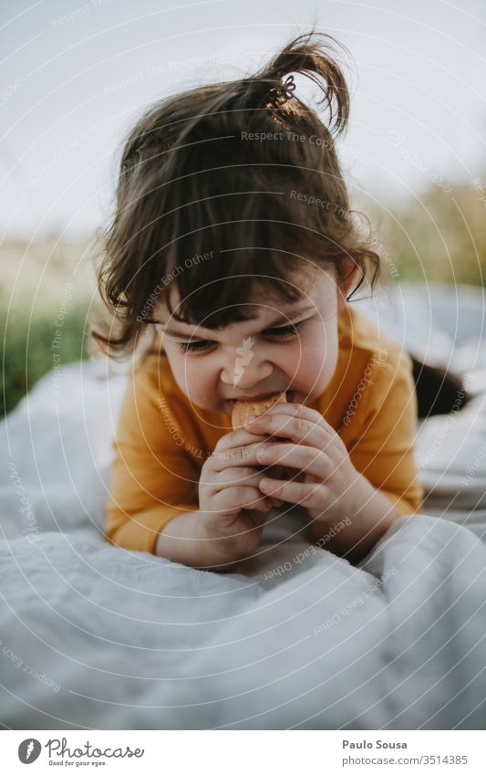 Child eating cookie lying on grass Grass Green Joy Meadow Garden Nature Summer Infancy Cute Beautiful Exterior shot Happy Delightful Happiness people Spring