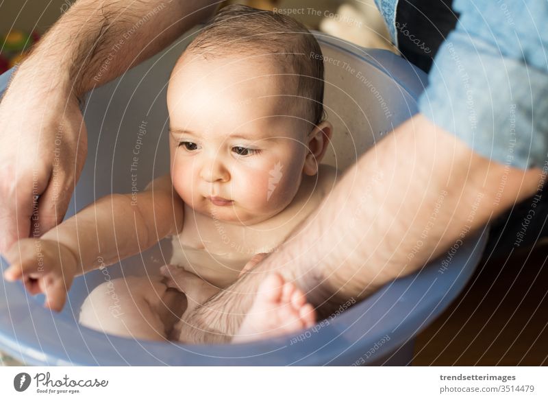 Father bathing his little baby father child bathroom dad water kid boy family happy cute white newborn childhood caucasian young care girl beautiful clean