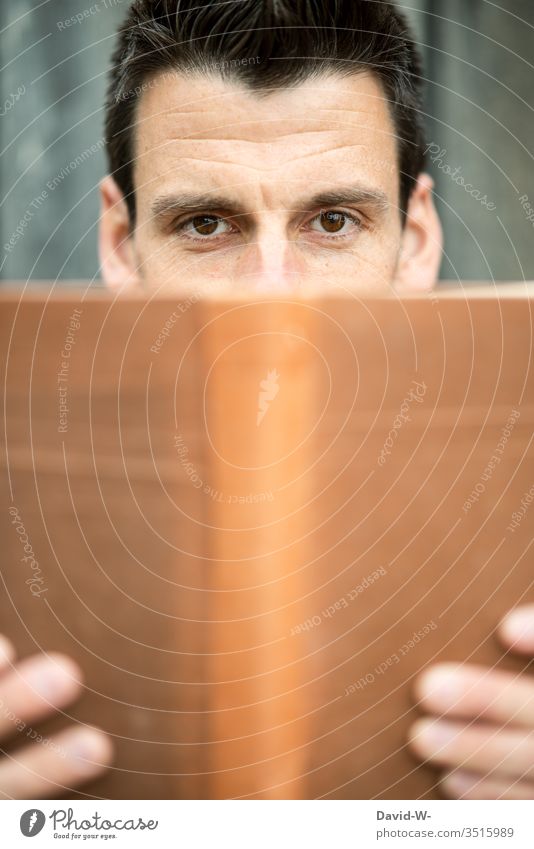 read Man Reading Book Looking into the camera Face Copy Space bottom Copy Space middle book cover Neutral Empty Manly Reader Reading matter Bookworm hands