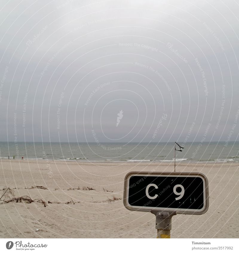 Meeting point C 9 at the flag rest sign Orientation Signs and labeling Signage Sand Beach North Sea Water Sky Clouds Dreary Horizon Denmark Vacation & Travel