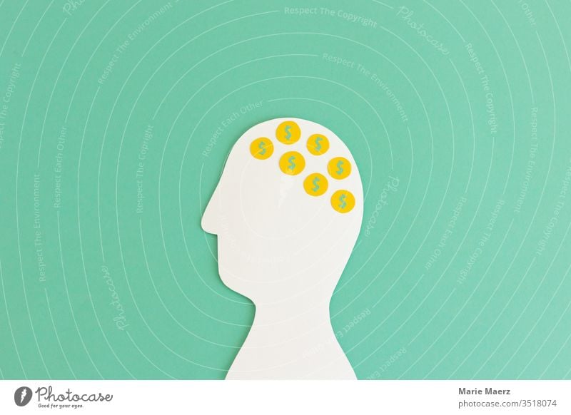 Money in the head | head silhouette of paper with dollar coins Head Neutral Background Brain and nervous system Think Stress Silhouette Human being Bad thoughts