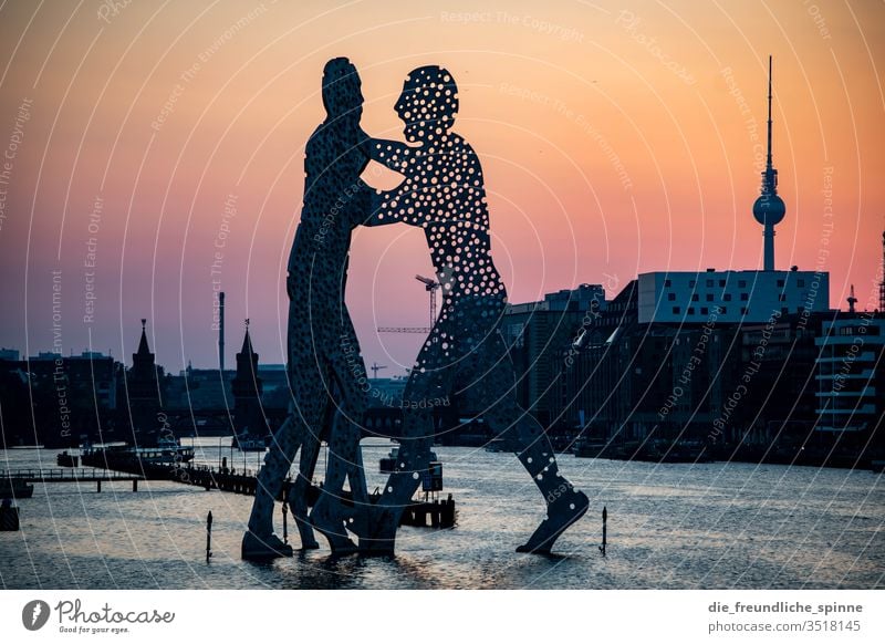 Molecule Men in the evening Sunset Spree Oberbaumbrücke Berlin Exterior shot Capital city bridge Landmark Tourist Attraction Town Water Kreuzberg Friedrichshain