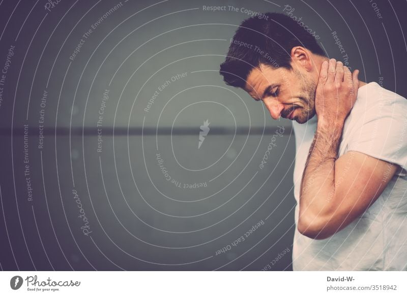 Man contemplating in front of a grey wall Meditative Wall (building) Gray pose think deliberating Indecisive Insecure thoughts Think Head Face Facial hair