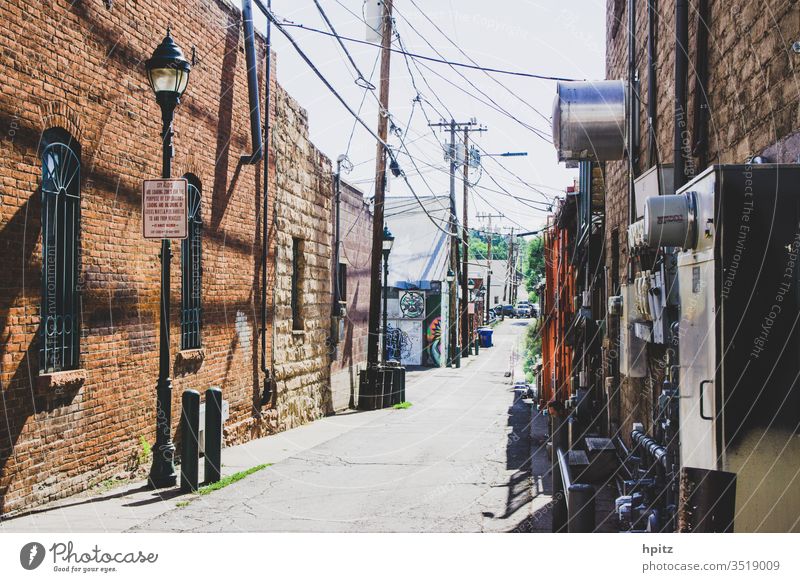 Side street in Flagstaff, Arizona Sidestreet house facade Deserted Sunlight Old Wall (barrier) Brick wall Brick facade Structures and shapes