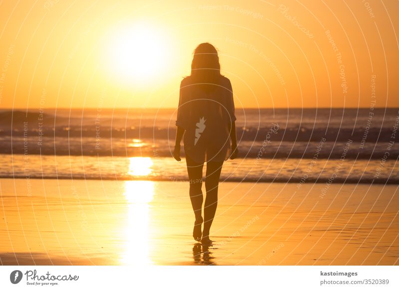 Lady walking on sandy beach in sunset. sea woman summer footprint footstep landscape coastline vacation water nature female waves beautiful ocean barefoot