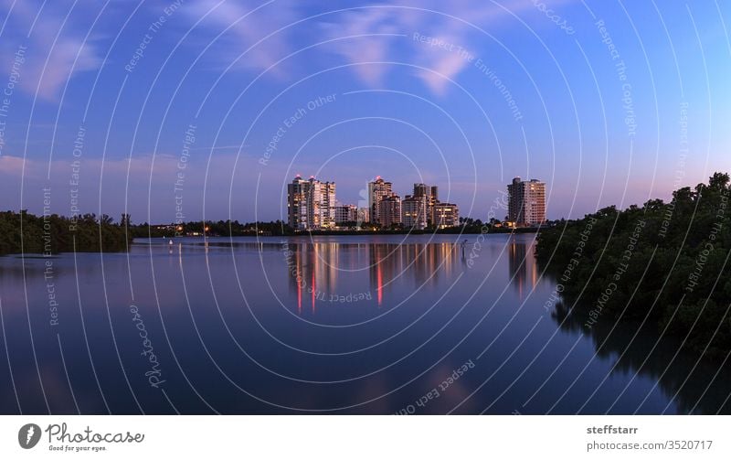 Night falls after sunset over Clam Pass as the lights of the highrise buildings glitter landscape waterway mangrove trees nature river Naples Florida coast