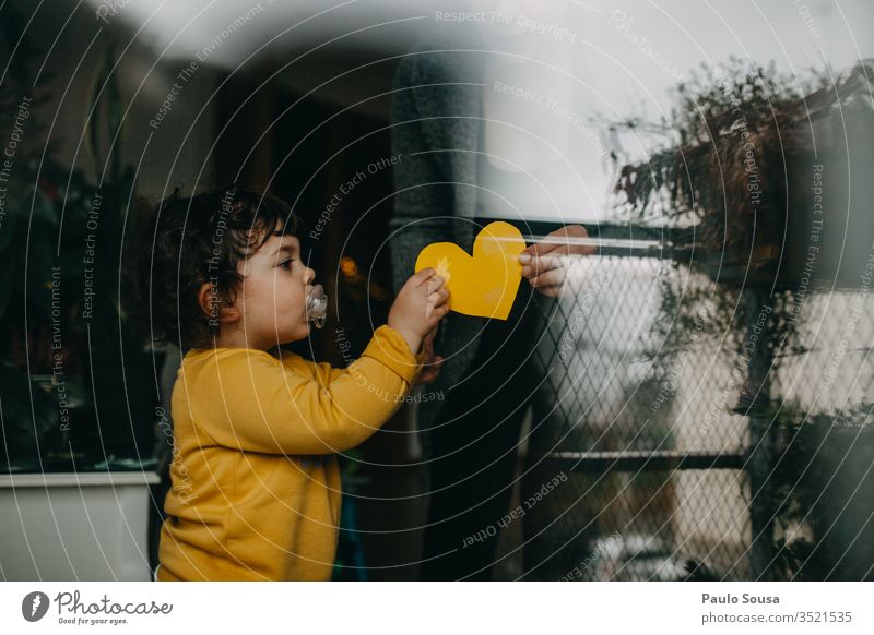 Child give heart to mother Daughter Family & Relations Lifestyle at home Home through window Window Reflection Heart Heart-shaped Quarantine confinement