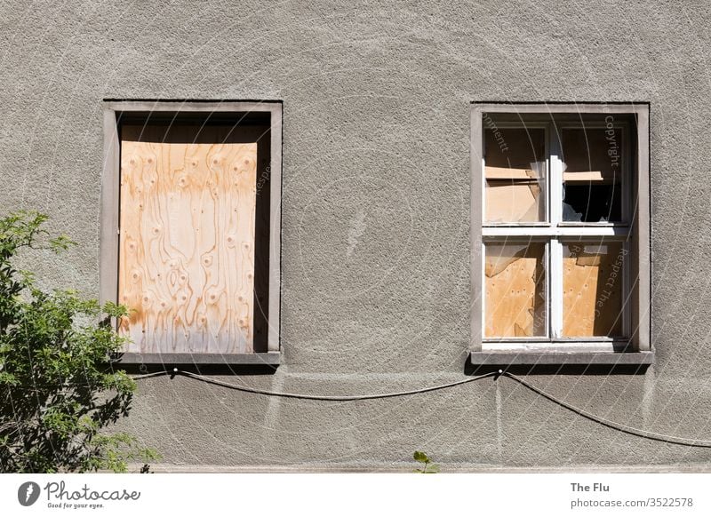 Nailed up house front House (Residential Structure) Ruin Window Deserted Decline Old Broken Wall (building) built Facade Exterior shot Past Subdued colour