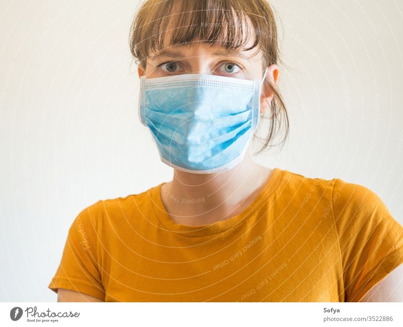 Young woman wearing protective face mask covid19 coronavirus quarantine stay home alone protection isolation epidemic flu girl pollution prevention spreading