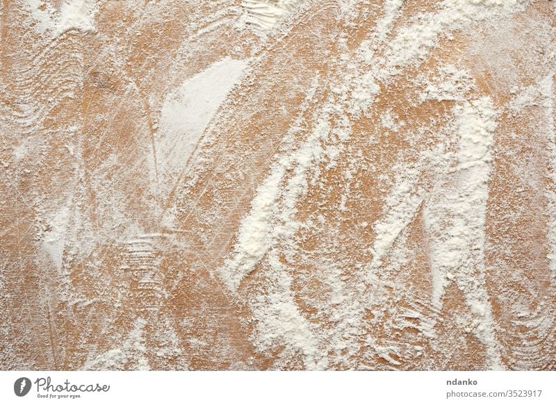 white wheat flour scattered on a brown wooden table, top view dust food abstract backdrop background bakery board closeup design heap ingredient kitchen nobody