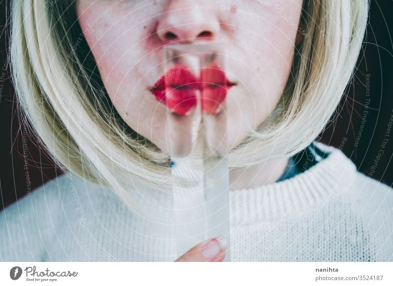 Close up of a young woman's face covering by a prism art close up glass crystal distortion reflection lips blond blonde mouth cold clean silence secret timidity