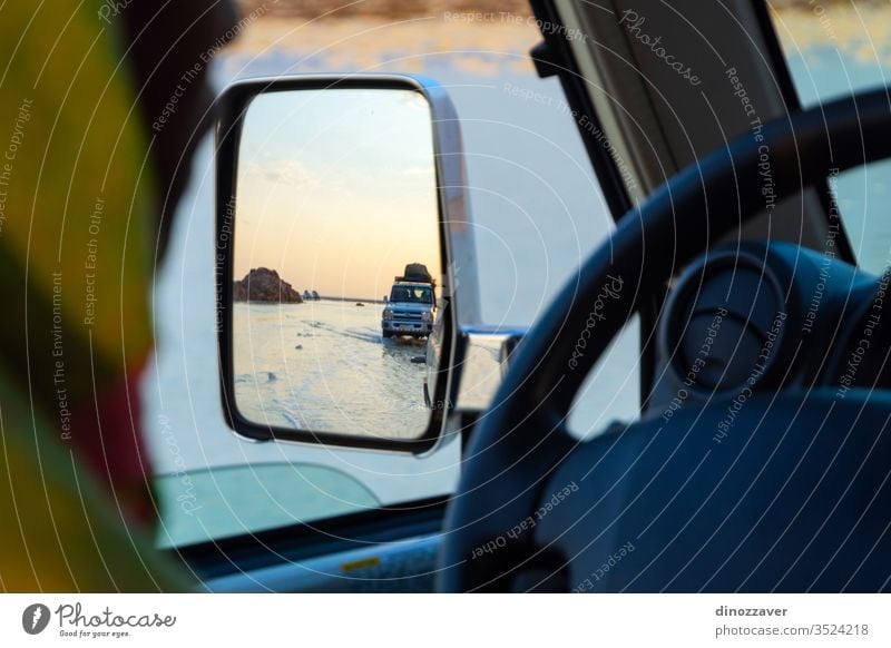 Driving over salt flats in Danakil desert, Ethiopia 4x4 drive danakil twilight mirror reflection travel nature road african car landscape lake scenic hot water