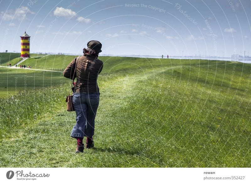 on the dyke Human being Feminine Young woman Youth (Young adults) Grass Coast North Sea Ocean Going Dike Lighthouse East Frisland To go for a walk