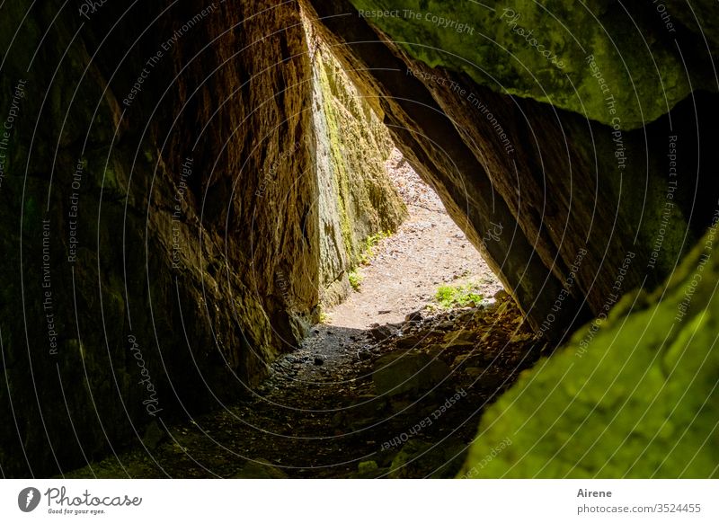 Into the light Cave fissure Fissure Entrance durchschlupf Narrow Force of nature Canyon narrow off Sunlight Beautiful weather Nature Brown Light brown Black