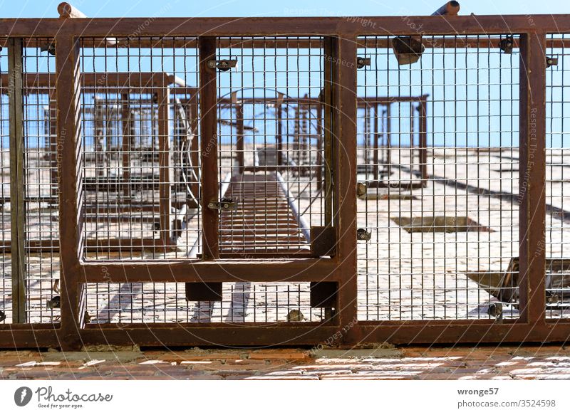 View skywards through the platform of a steel fire escape Fire ladder escape ladder emergency staircase Worm's-eye view Skyward Metal grid Platform house wall