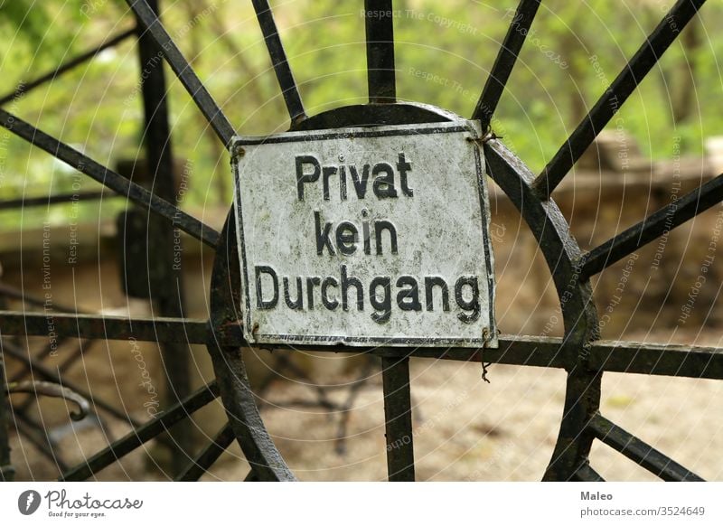 Gate sign. German text: Private No passage access ban enter entry fence forbidden gate metal no prohibited security anger barrier board conflict countryside