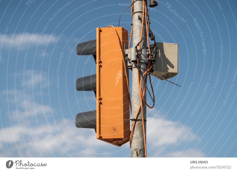 Temporary traffic light with cloudy sky in the background Traffic light Signal station Traffic lights Orange Cable makeshift Blue