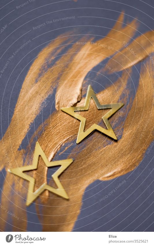 Two stars on golden wavy brush strokes. Christmas. Star number Christmas star Brush strokes Painted Christmas decoration Christmassy Gold Blue purple Violet