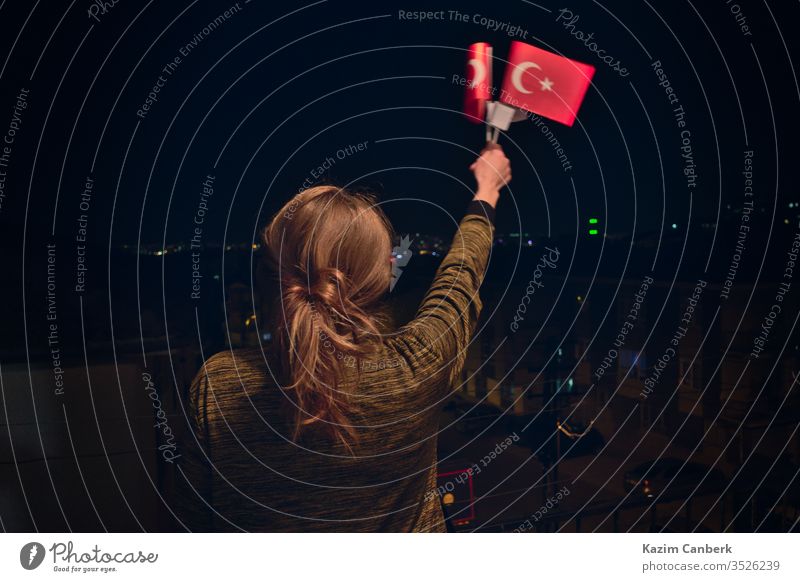 Turkish Woman Holding, Waving Turkish Flags at night Celebrating April 23 Children's Day turkish flag waving woman female ankara turkey children's day april 23