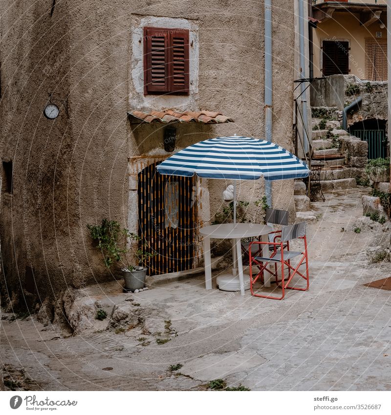 Backyard in front of stone house with parasol and chairs Croatia Europe Summer Summer vacation rear building idyllic backyard Camping Camping chair Sunshade