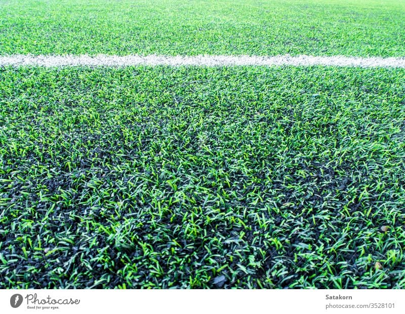 Texture of plastic artificial grass and the rubber pellets on school yard turf background green texture surface cover color pattern black recreation floor lawn