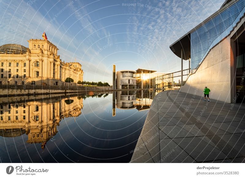 Jogger in the morning in the government district Pattern Downtown Berlin Tourism built Hip & trendy Spreebogen Copy Space right Copy Space bottom Light Shadow