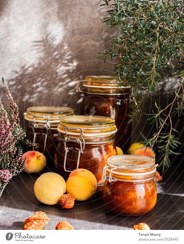 Preserves of peach jam Sugar Home-made Jam jar Conserve Preserving jar Vintage screwed glass Kitchen grandma Self-made Wooden table Interior shot Nutrition Food