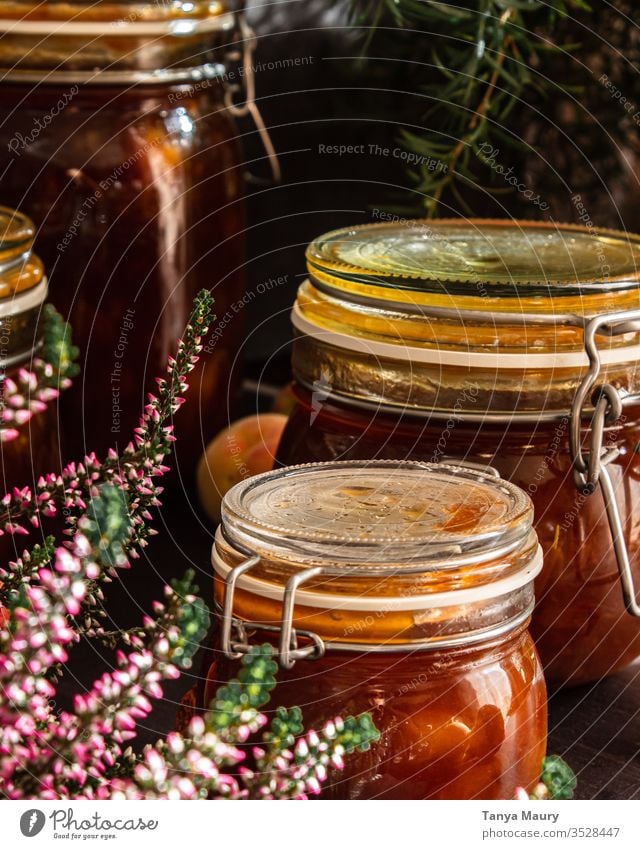 Preserves of peach jam Sugar Home-made Jam jar Conserve Preserving jar Vintage screwed glass Kitchen grandma Self-made Wooden table Interior shot Nutrition Food