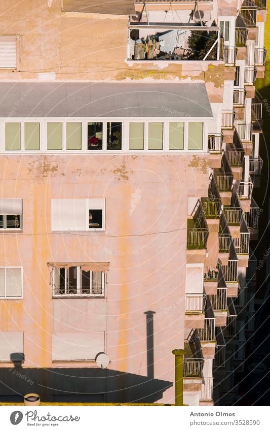 CLOTHES HANGING ON BALCONIES architecture clothes balconies hanging orange Clothing Sky red rope dry blue white holder laundry Window Window pane