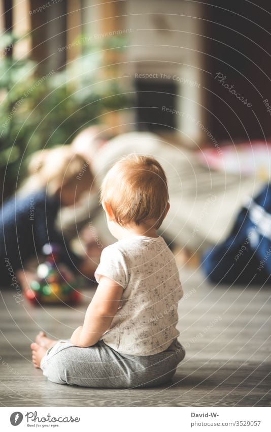 a little boy watches his surroundings closely to make sure he doesn't miss anything smaller Boy (child) Child Toddler Playing Observe monitored Vicinity Sister