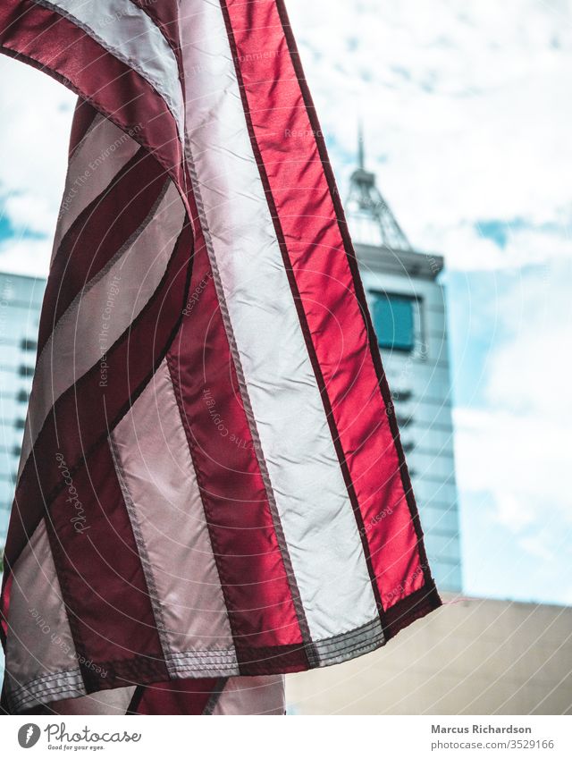 photo of flag with skyscraper in background Flag america American Flag Red White Blue Patriotism USA Stripe Colour photo July Freedom Independence Wind