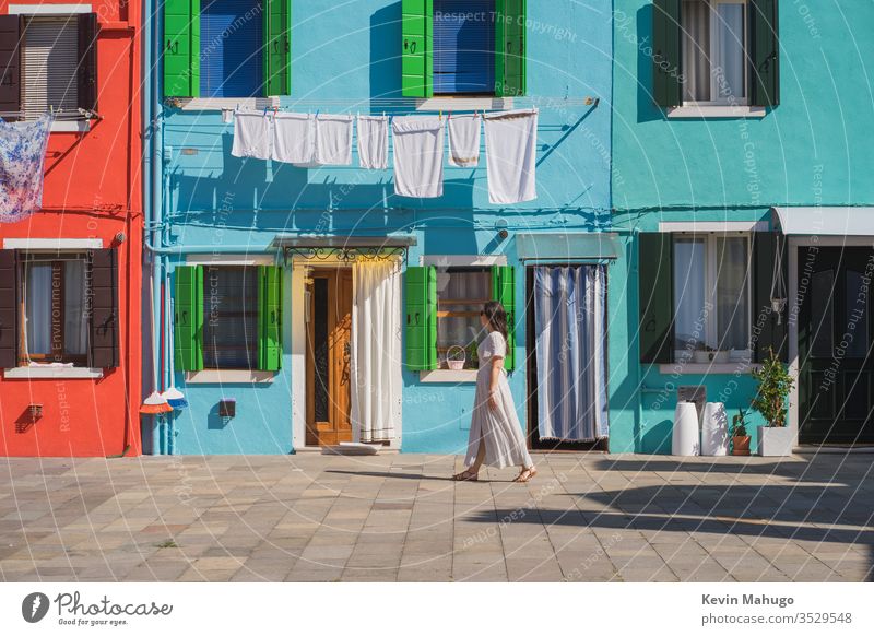 Beautiful woman walking in Venice, Italy street yellow pink wall building colours scenery country blue european beautiful front house grey home scenic paint