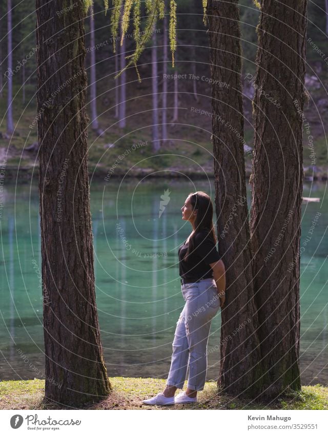 Beautiful woman viewing the lake in Italy. green Breathing breath alone outdoors day summit people barrel water nature lifestyle high tree mountain travel