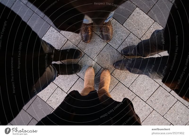 4 pairs of feet - friends stand in a circle foot Footwear Legs Friends circle of friends Circle Stand Attachment at the same time Winter urban Town Street