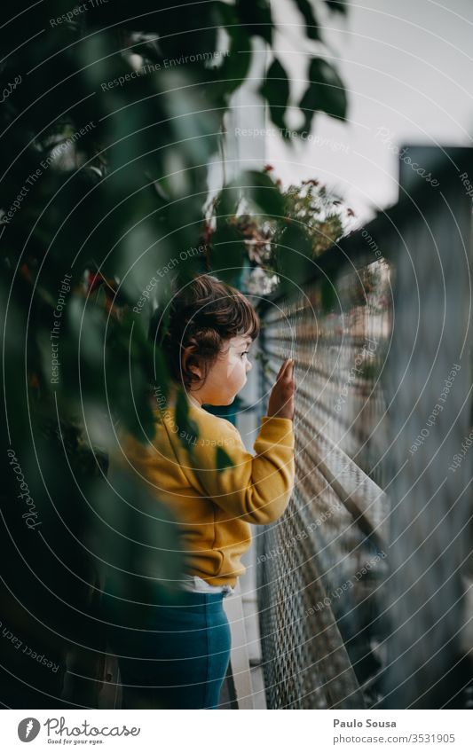 Child looking from balcony Balcony balcony rail Looking childhood Colour Caucasian Curiosity Colour photo Exterior shot Day House (Residential Structure)