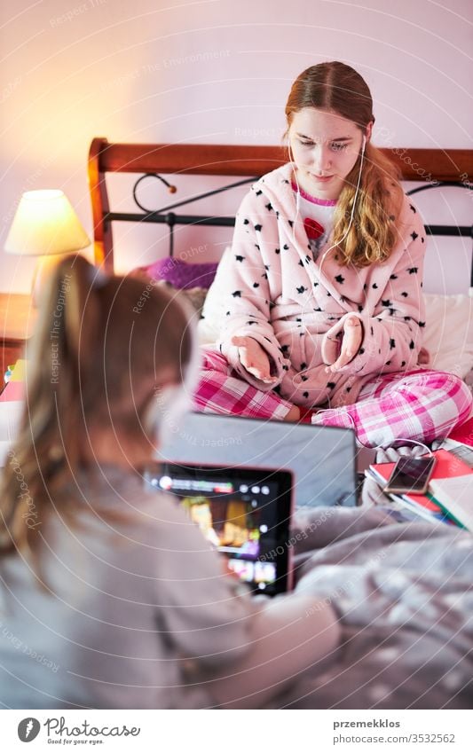 Student learning online, watching lesson remotely, listening to professor, talking with classmates on video call from home during quarantine student studying