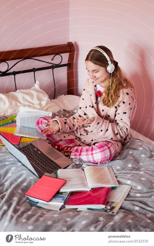 Student learning online, watching lesson remotely, listening to professor, talking with classmates on video call from home during quarantine student studying