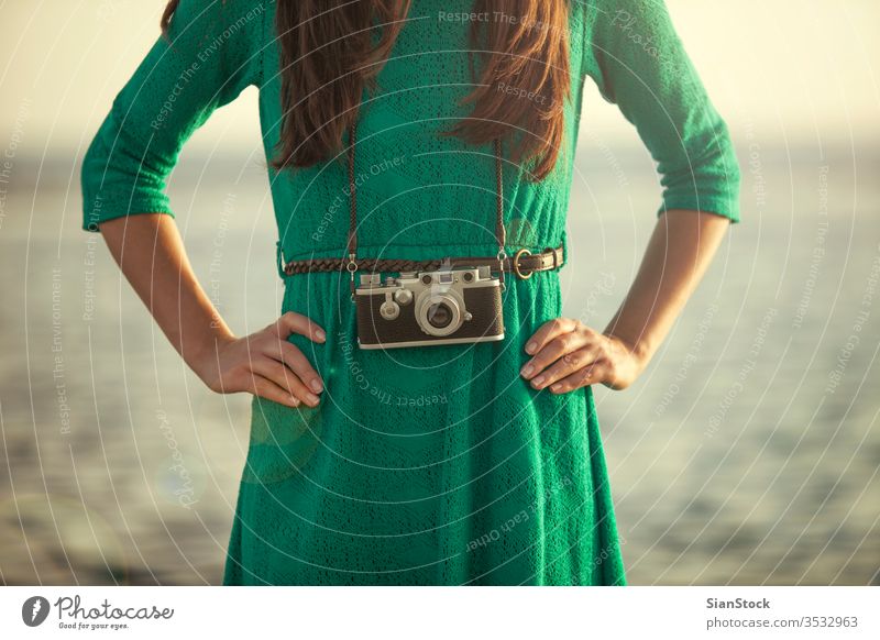 Vintage photo, brunette girl with retro camera beach vintage ocean vacation people summer travel blue photographer fashion lifestyle holiday funky women