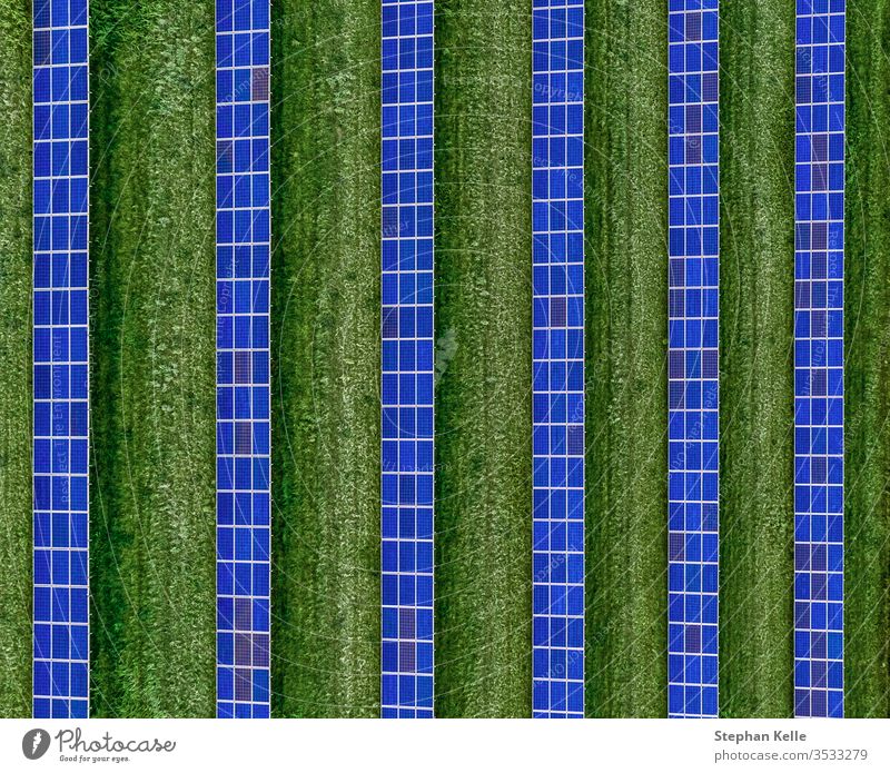 A plan view of solar panels set in an solar farm, top shot made by a drone. alternative energy environment friendly line symmetry solar array technology