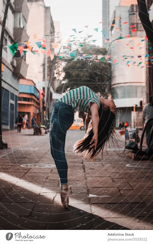 Happy woman dancing on the street dance split concept traffic city young slim female elegant ballerina casual happy back bend perform dancer move flexible grace