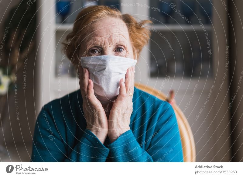 Aged woman in medical mask standing and looking at camera hospital infection disease virus protect room risk group clinic senior aged self isolation quarantine