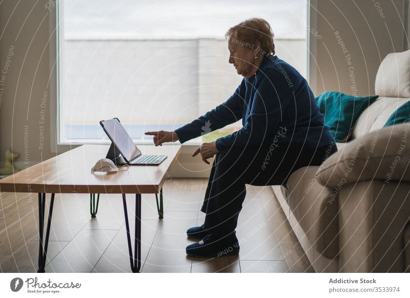 Old woman communicating with daughter on video chat on laptop video call home senior meeting using online remote distance coronavirus isolation quarantine