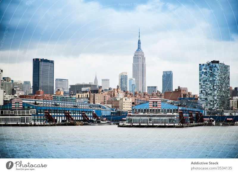 Modern coastal city skyline with skyscrapers modern new york building cityscape water river downtown architecture cloudy contemporary manhattan nyc usa america