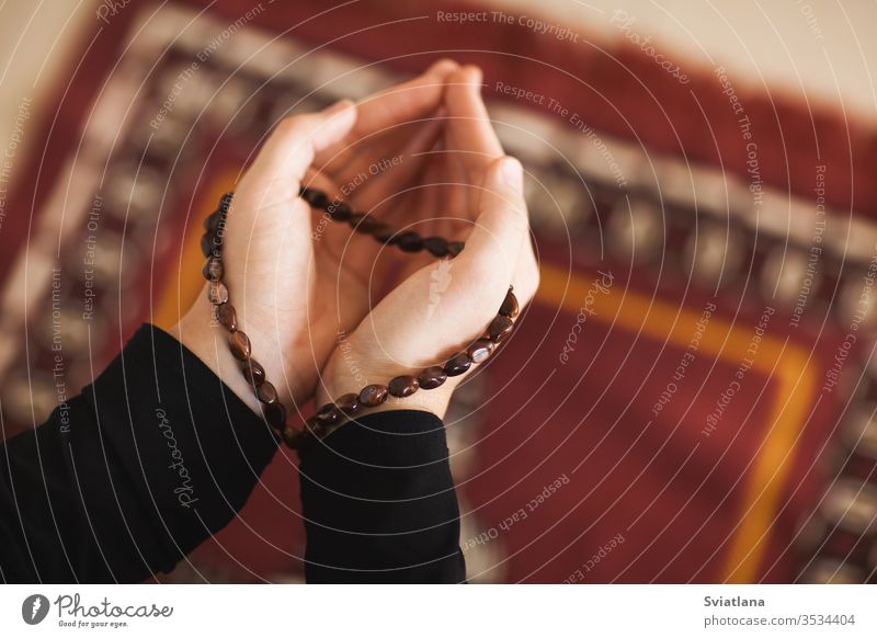 Prayer hands of a woman holding a rosary beads muslim symbol pray religion faith holy islam prayer allah god meditation Ramadan traditional white arabic