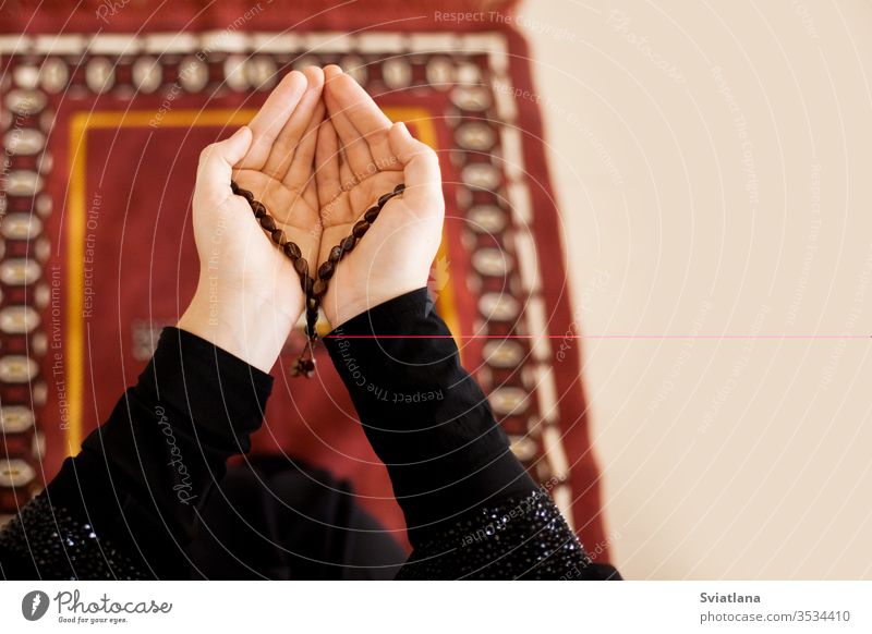 Prayer hands of a woman holding a rosary, with space for text beads muslim symbol pray religion faith holy islam prayer allah god meditation Ramadan traditional