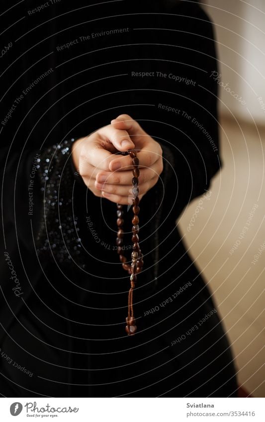 Prayer hands of a woman holding a rosary beads muslim symbol pray religion faith holy islam prayer allah god meditation Ramadan traditional white arabic