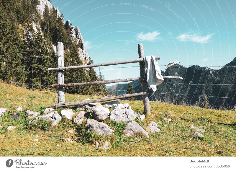 Slate wooden fence in the mountains serves as a barrier and towel rail Alps Mountain Sky Blue Rock Peak Landscape Nature Exterior shot Colour photo Day