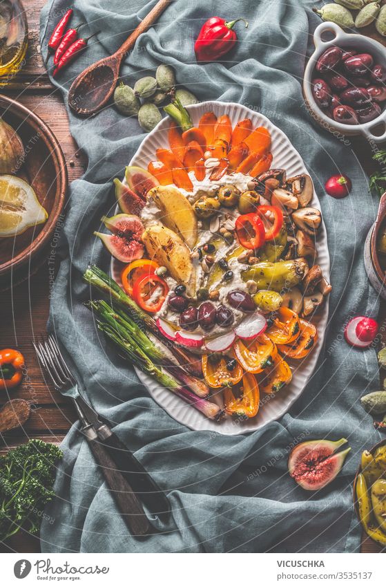 Vegan hummus party plate with roasted, grilled , fresh and pickled vegetables . Top view. Healthy eating. Snack. Mediterranean food. tasty vegan rustic napkin