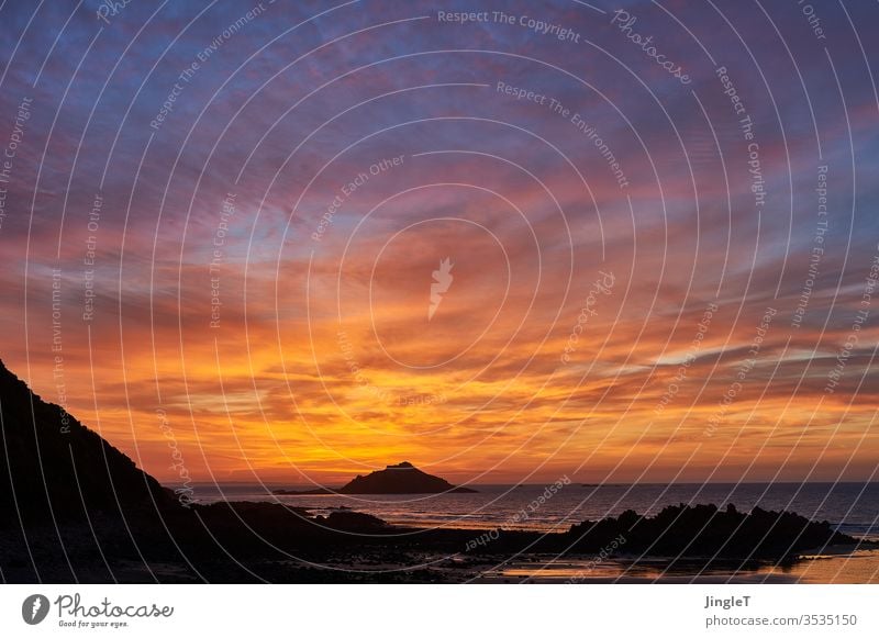 Sunset in a partly cloudy sky on a rocky coast at the Atlantic Ocean Coast Rock sunset Clouds Sky Evening Moody Red Blue Gold Black Horizon Island Silhouette